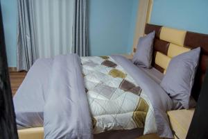 a bedroom with a bed with a quilt on it at La Casa Nostra Rubavu in Rubavu