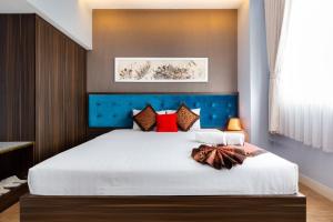Postel nebo postele na pokoji v ubytování Khách sạn Bamboo Sài gòn