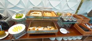 a buffet with bread and pastries on a table at Khách sạn Bamboo Sài gòn in Ho Chi Minh City