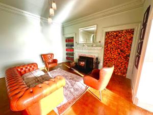 a living room with a couch and a fireplace at Navidale House - Bed, Breakfast & Bar in Helmsdale