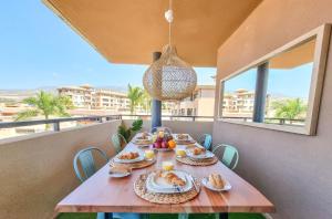 a table with food on top of a balcony at Relax in Paraiso by Olax Rentals in Playa Paraiso