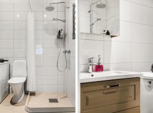 a bathroom with a sink and a shower at Modern New Stylish Apartment in Åkersberga