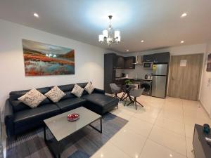 a living room with a couch and a table at The Lennox Luxury Suites & Apartments in Accra