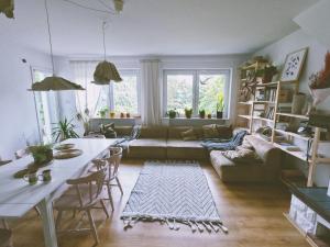 a living room with a couch and a table at Inny Dom in Łacha