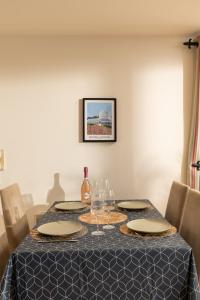 a table with plates and wine glasses on it at Beautiful City Center Apartment with a River View - Free Parking! in Belfast