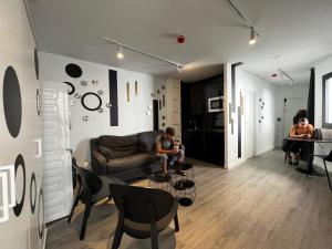 阿利坎特Hostel Alicante的客厅,客厅里的儿童坐在沙发上