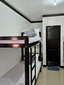 a bedroom with a bunk bed in a room at Casa Olivia in Coron