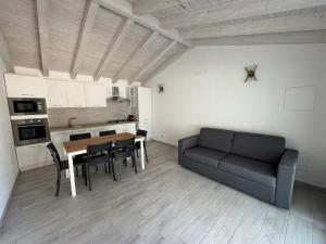 a living room with a table and a couch at Villetta 2 La Caletta in La Caletta +6 photos