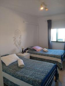 um quarto com 2 camas e uma janela em House with amazing beach view! em Carvoeiro