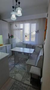 a living room with a table and a couch at Однокомнатная квартира, Новая! in Mayevka