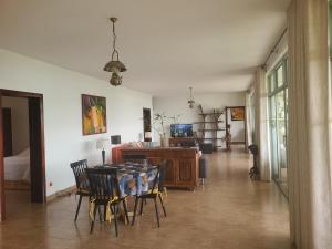 a dining room with a table and chairs at Rubavu Buy And Sell Ltd, real estate agency in Gisenyi