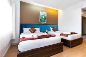 Postel nebo postele na pokoji v ubytování Khách sạn Bamboo Sài gòn