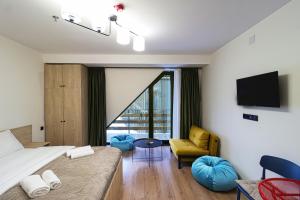 a hotel room with a bed and a chair at Marshall Gudauri Stylish Apartment By Wehost in Gudauri
