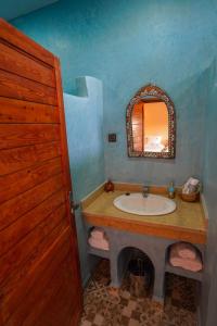 a bathroom with a sink and a mirror at Zagora Oasis Lodge & Desert Excursions in Zagora +127 photos