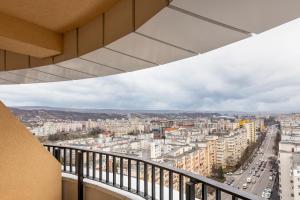 a view of a city from a balcony at Boudoir Apartment City Tower - 15th floor in Cluj-Napoca