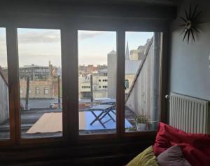 Zimmer mit einem Fenster und Blick auf einen Balkon. in der Unterkunft Sunny Penthouse with terras in Gent