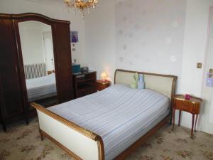 a bedroom with a bed and a large mirror at Maison avec vue sur Morgat in Crozon