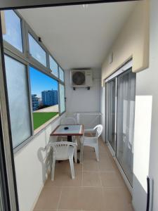a balcony with a table and chairs and windows at Alsol C 5361-1 in Quarteira