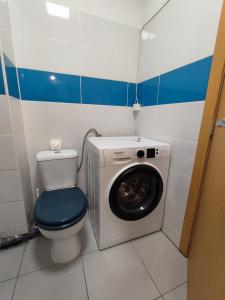 a bathroom with a washing machine and a toilet at Alsol C 5361-1 in Quarteira