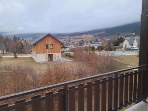 a view of a wooden house from a balcony at Résidence Croix Margot in Villard-de-Lans