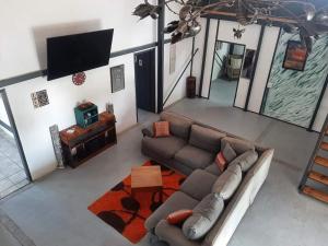 a living room with a couch and a tv at Umbuntu guesthouse in Parys