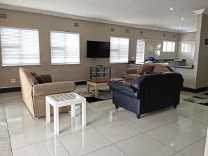 a living room with two couches and a tv at Arabella in Durban