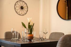 a table with wine glasses and a plant on it at Lagavulin Apartment in Oban