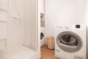 een witte wasruimte met een wasmachine en droger bij Les Dunes - Duplex - 6 personnes in Jullouville-les-Pins
