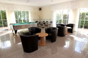 a large room with a pool table and chairs at Hotel Messeblick in Sarstedt