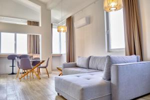 a living room with a couch and a table at Apartments Magic box II in Utjeha