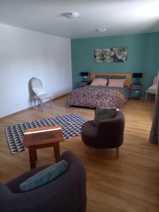 a bedroom with a bed and a table and chairs at Alpagas de Barres in Sénaillac-Latronquière +17 photos