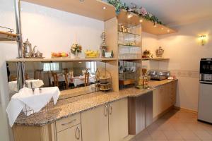 a kitchen with a counter and a dining room at Hotel Messeblick in Sarstedt