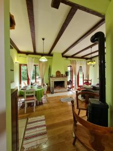 a living room with a table and a fireplace at Lovćen Escape, Rustric House in Cetinje