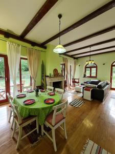 a living room with a table and a couch at Lovćen Escape, Rustric House in Cetinje