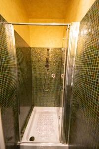 a shower with a glass door in a bathroom at Casina Ridolfi - Bilocale con quattro posti letto in Florence
