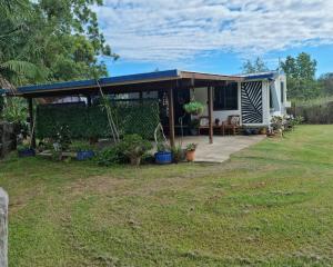 a house with a blue roof and a yard at Pillar to Coast in Pillar Valley