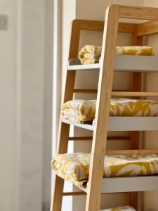 a wooden ladder with pillows on it at The Annex, Escape to the Country in Salcombe