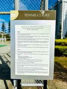 a sign in front of a tennis court at Cool and Savvy 1BR @Cool Suites Tagaytay in Tagaytay