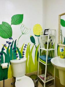 a bathroom with a toilet and a sink at Cool and Savvy 1BR @Cool Suites Tagaytay in Tagaytay