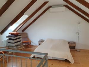 a room with a hospital bed in a attic at Árvalányhaj Vendégház in Balatonakali