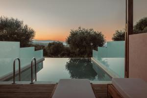 een uitzicht op een zwembad vanuit een huis bij Elegance Luxury Executive Suites - Adults Only in Tragaki