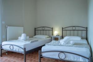 two beds sitting next to each other in a room at Villa Orama in Nea Potidaea