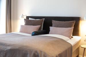 Voodi või voodid majutusasutuse Sixtus Sinatur Hotel & Konference toas