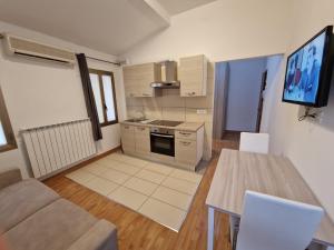 a kitchen with a couch and a table in a room at CHIOGGIA PLAYA in Chioggia