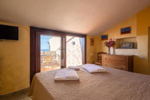 a bedroom with a bed with two towels on it at Il Borgo Di Campi in Riomaggiore +98 photos