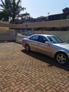 a silver car parked on a brick driveway at Arabella in Durban