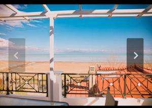 a view of the beach from the balcony of a house at Κatakolo Luxury Seaside House & Garden in Katakolo