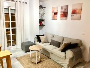 a living room with a couch and a table at La Pimentera Casco Antiguo - Marbella in Marbella