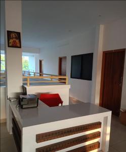 a room with a desk with a phone and a television at Sky Residency Lodge in Trichūr