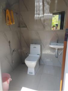a bathroom with a toilet and a sink at Aryans Keeth house farm stay in Idukki